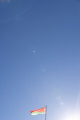 The national flag of the Republic of Belarus in windy weather against the blue sky