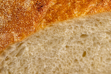 A cut loaf of round-shaped wheat bread