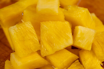 sliced pulp of peeled ripe pineapple , close up