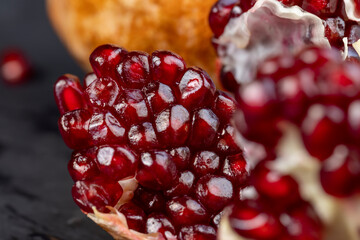 Grains of red ripe pomegranate close up