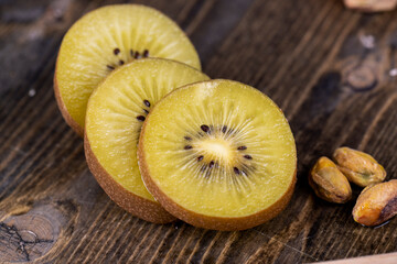 green and yellow kiwi fruit cut into pieces, close up