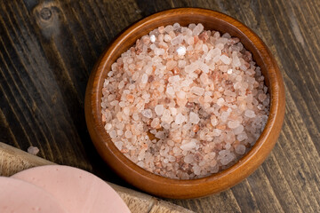 Pink natural salt on the table, close up