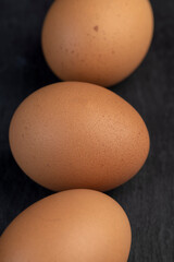 A whole orange chicken egg close-up on the table