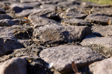 part of an old fence made of a large number of stones