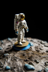 An astronaut walks on the surface of the moon.