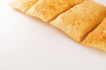 A row of Fried Pastels (Pastel de Feira), white background, Copy Spacefoo