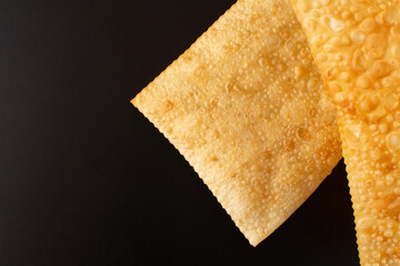 Two Fried Pastels (Pastel de Feira), black background, Copy Space