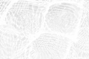 White water with ripples on the surface. Defocus blurred transparent white colored clear calm water surface texture with splashes and bubbles. Water waves with shining pattern texture background.