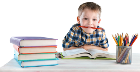 Happy school child with school supplies, sitting at a desk learning in class