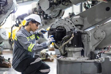 Robotic technicians tighten and loosen components with screwdriver and plier to perform safety maintenance. Measuring current, voltage, resistance, capacity, temperature with digital clamp meter.