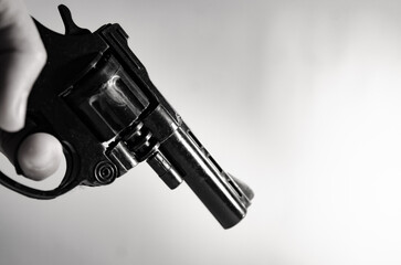 Gun in hand  monotone in crime concept. - obrazy, fototapety, plakaty