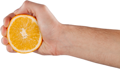 Hand holds orange fruit and squeezes out juice squeeze