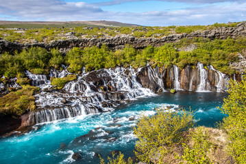 Marveling at the Cascades of Hraunfossar, Iceland © Emma