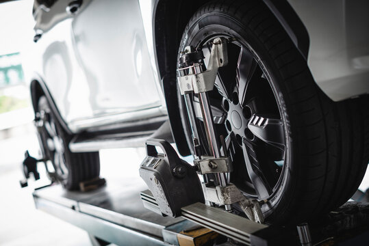 Car wheel alignment services in garage service shop. 