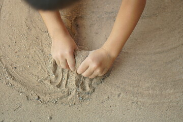 Boy playing with soil in the home area
