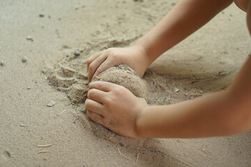 Boy playing with soil in the home area