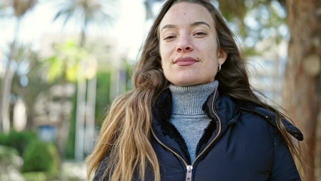 Young caucasian woman smiling confident breathing at park