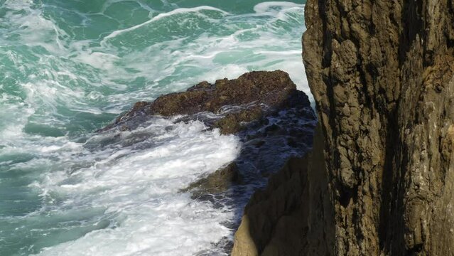 Waves crashing against the rocks on the cliffs of northern Spain, Asturias, take slowmotion.