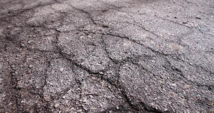 damaged asphalt on a highway, a close-up of an old road with cracks and damage