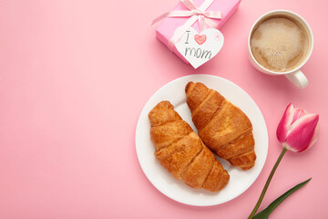 Happy mother's day, beautiful breakfast, lunch with cup of coffee, fresh croissants, tulip and gift. Spring holiday, family relations.