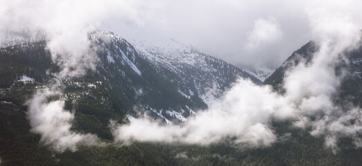 Canadian Mountain Landscape covered in Clouds. Nature Background. Aerial View in Squamish, BC, Canada.