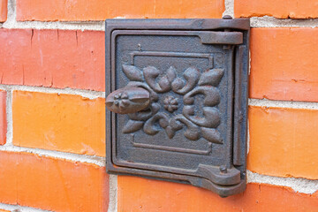 An old metal mailbox on the door of the house