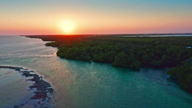 Aerial sunset panorama of Saddlebunch Key, in Florida Keys, Florida, with pull back camera motion