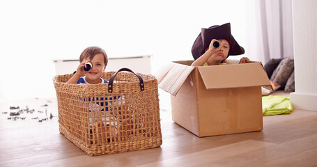 Fantasy, children smile in costume as pirate and play with boat boxes in living room at their home....