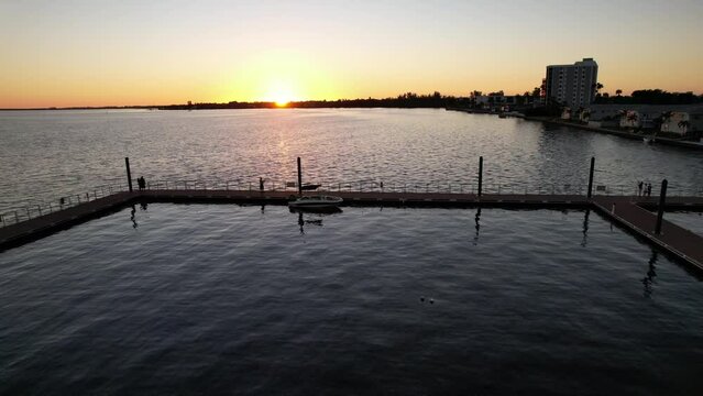 As the sun sets below the horizon, its rays reflect on the water creating a beautiful scenery on the pier that can be observed from a height. This pier provides access to the water body.
