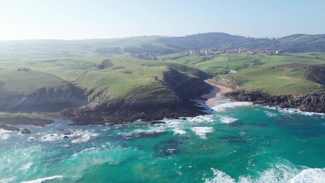 Panoramic flaring ocean beach view on the beautiful serene Spanish Coastline of Playa de Tagle. Southern Europe