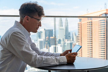 Fototapeta premium Man in glasses using tablet in office