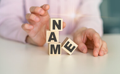 NAME word written on wood block. NAME text on wooden table for your desing, concept.