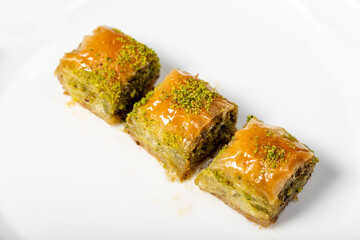 Baklava with pistachio on a dark background. Traditional Turkish baklava. Local name ankara sarmasi. Close up