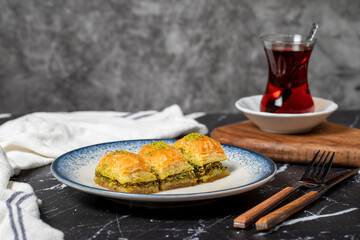Baklava with pistachio on a dark background. Traditional Turkish baklava