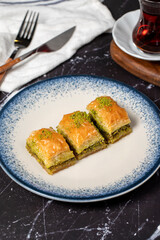 Baklava with pistachio on a dark background. Traditional Turkish baklava