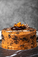 Caramel cream cake. Birthday or celebration. Pistachio, chocolate, caramel and cream cake. Close up