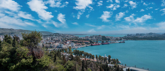 Naklejka premium Greece, Chalkida city at Evia. Close up view of port from castle, building, cloudy sky background.