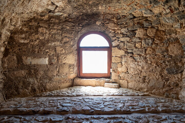 Greece, Kanithos or Karababa Castle at Chalkida. View of interior stonewall fort, arched window.