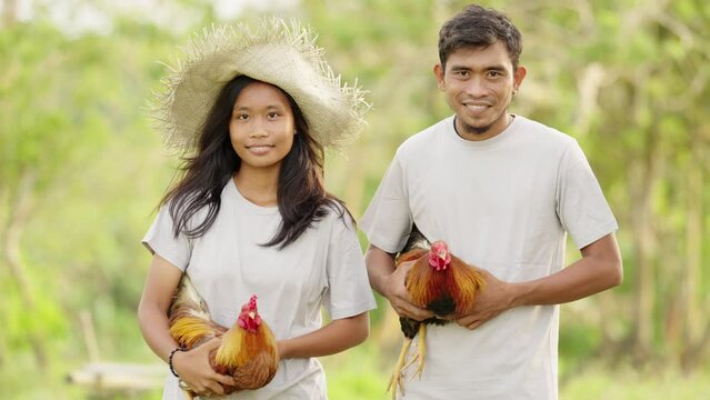 Portrait of asian Farmers with cockfighting Roosters, on Farm in Countryside