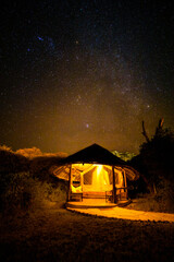 Fototapeta na wymiar Night scene with stars, exterior of a luxury lodge, Amboseli National Park, Kenya.