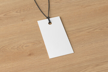 White rectangular tag mockup on wooden background. Side view