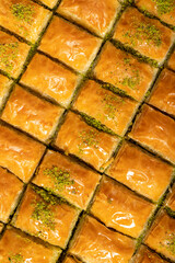 Pistachio baklava on wood floor. Tray of baklava. Traditional Turkish cuisine delicacies. sherbet sweets. Top view