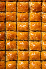 Pistachio baklava on wood floor. Tray of baklava. Traditional Turkish cuisine delicacies. sherbet sweets. Top view