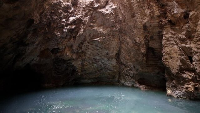 Turquoise-green lake in the Proval cave, on the southern slope of mount Mashuk. Proval Cave in Pyatigorsk. Lake with turquoise water in a cave. Underground lake Proval. failure in piatigorsk