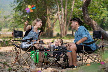 Happy family on a relaxing vacation By camping in the park