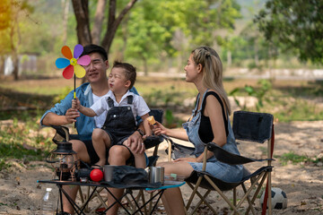 Happy family on a relaxing vacation By camping in the park