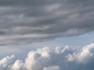 Gray cumulus clouds in the sky. Dramatic skies, landscape. The sky is like a background. A copy space. White clouds and sky