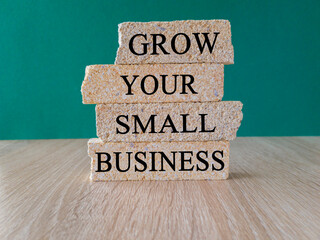 Grow your small business symbol. Concept words 'Grow your small business' on brick blocks on a...