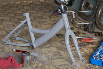 painted bicycle in the garage,children's bike disassembled and covered with primer