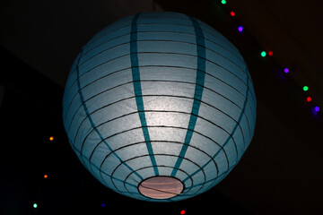 Blue round paper lantern on a dark background